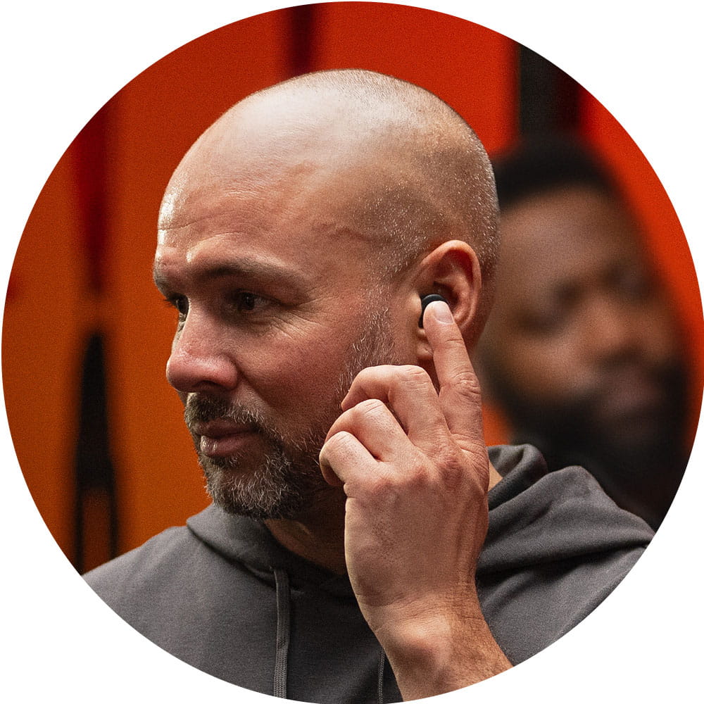 Man wearing Active IX hearing aids in earbud design