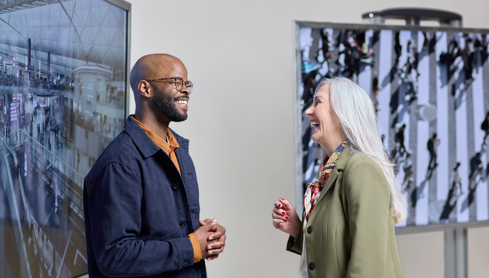 Two people in conversation in front of installation art