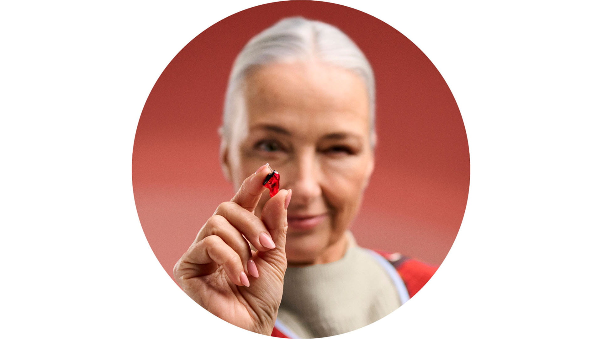 Woman holding Insio IX hearing aid