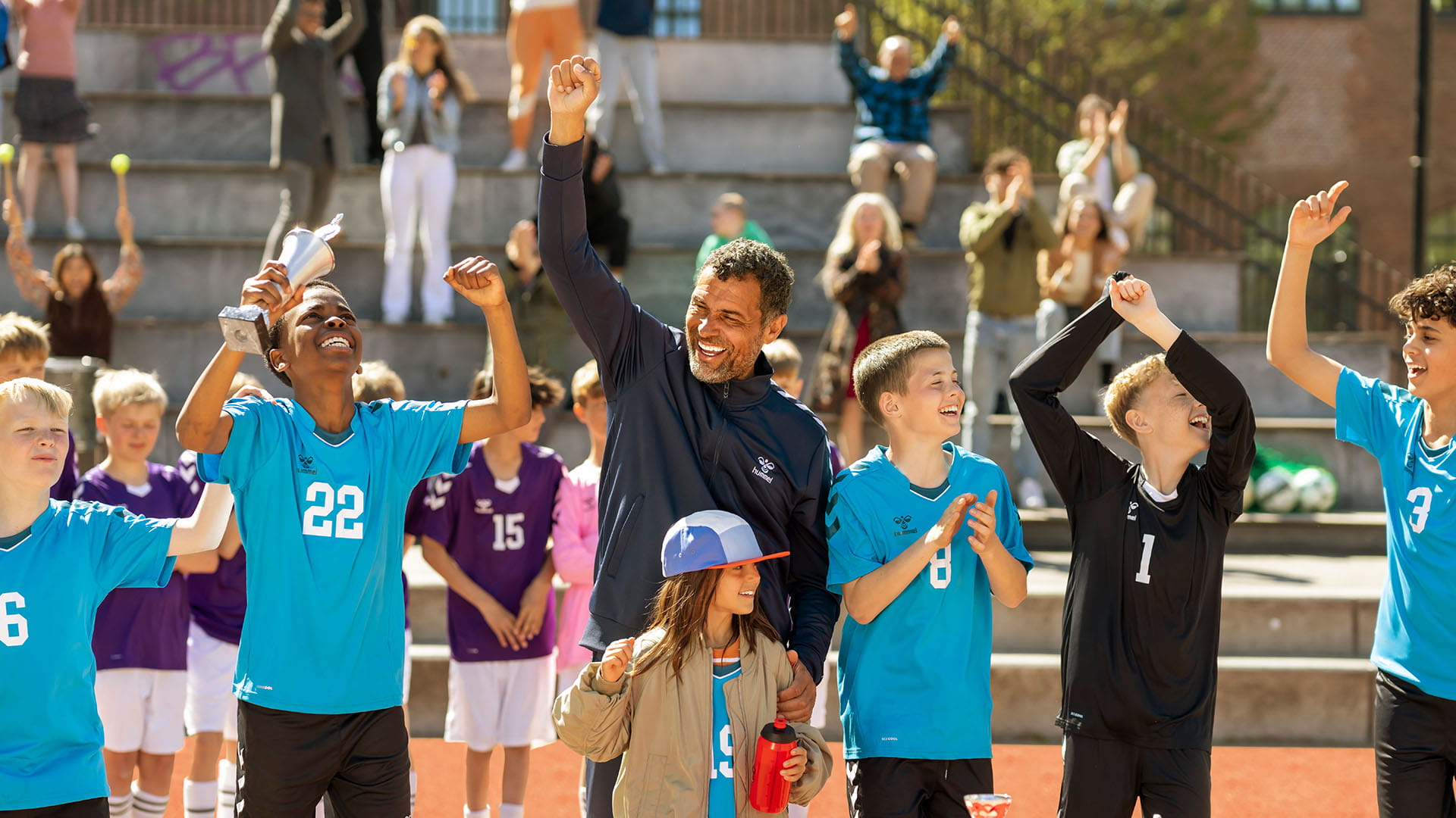 Coach with kids cheering