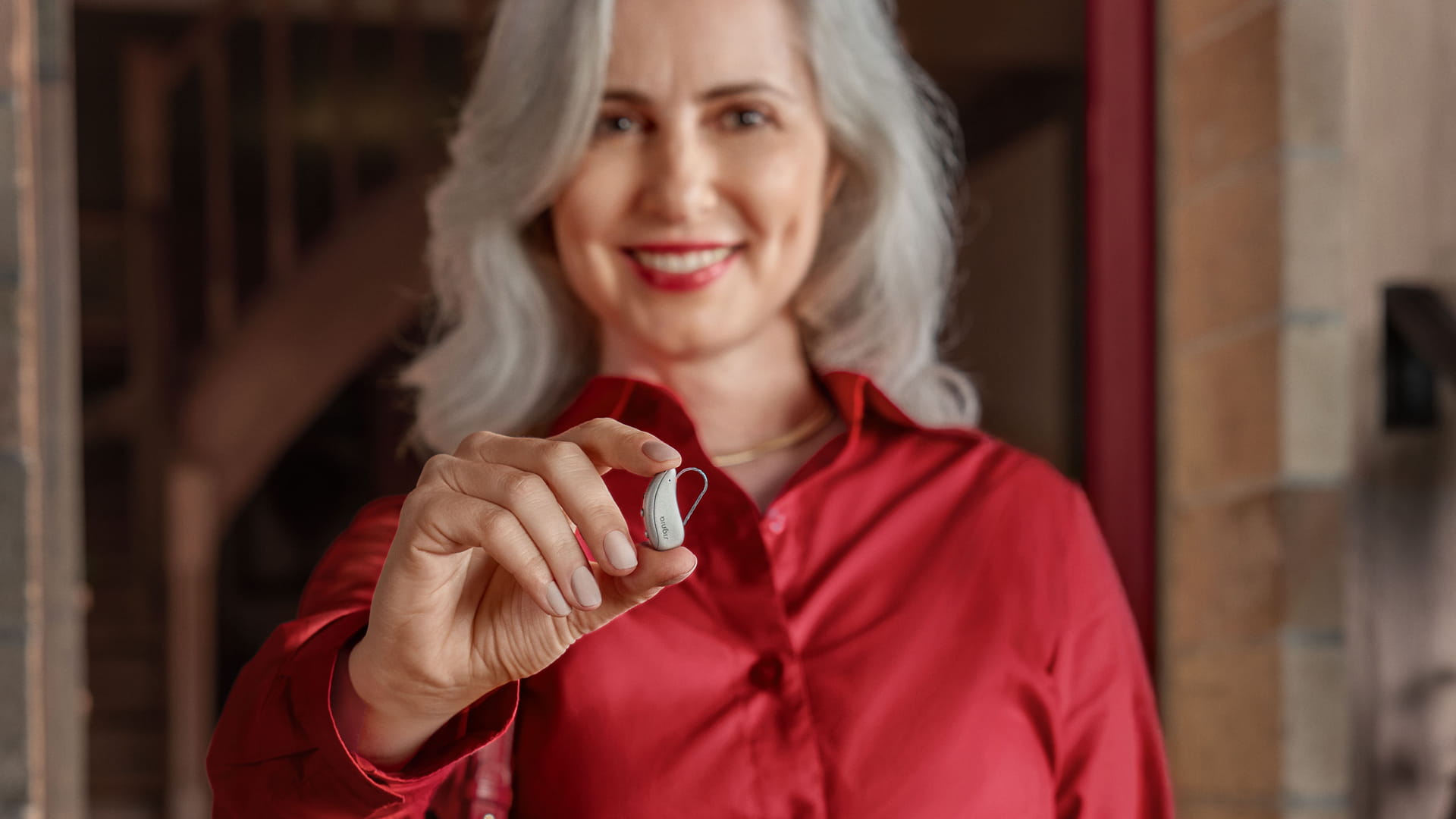 Women holding hearing aid Pure C&G MaX