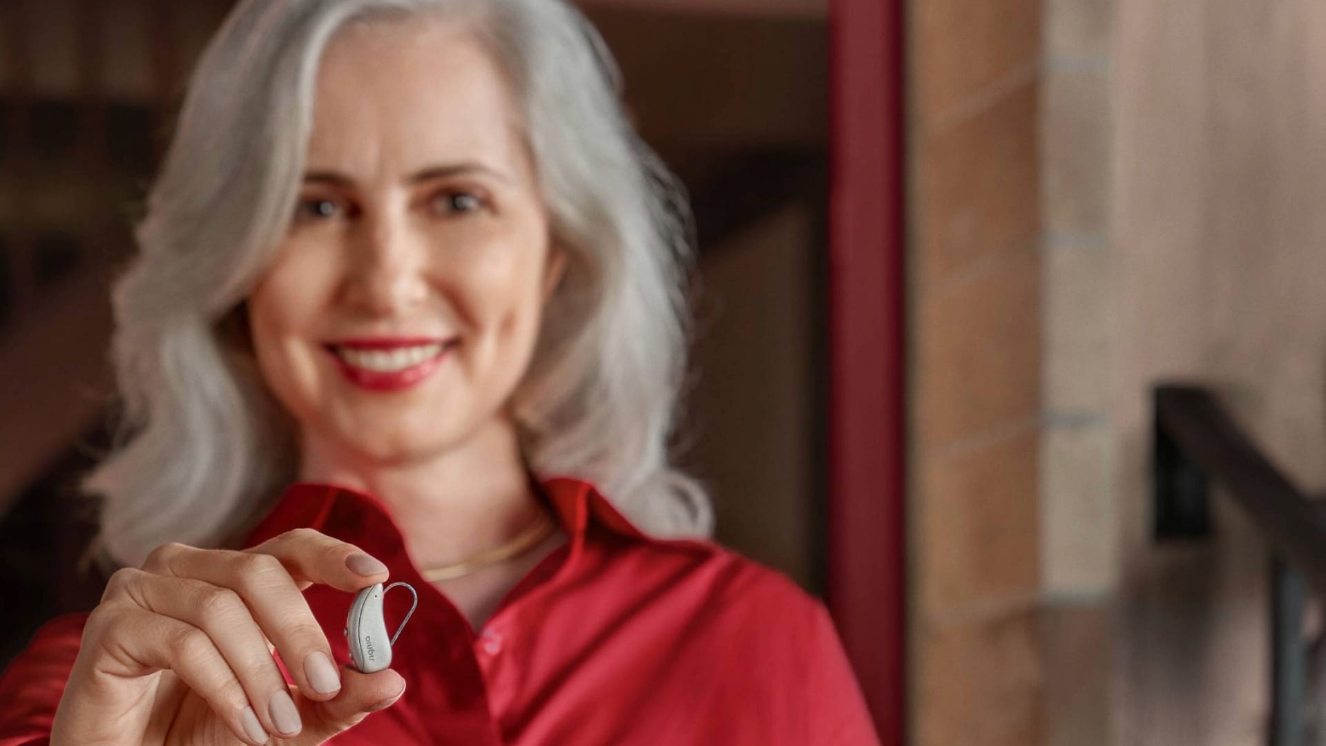 Women holding hearing aid Pure C&G MaX