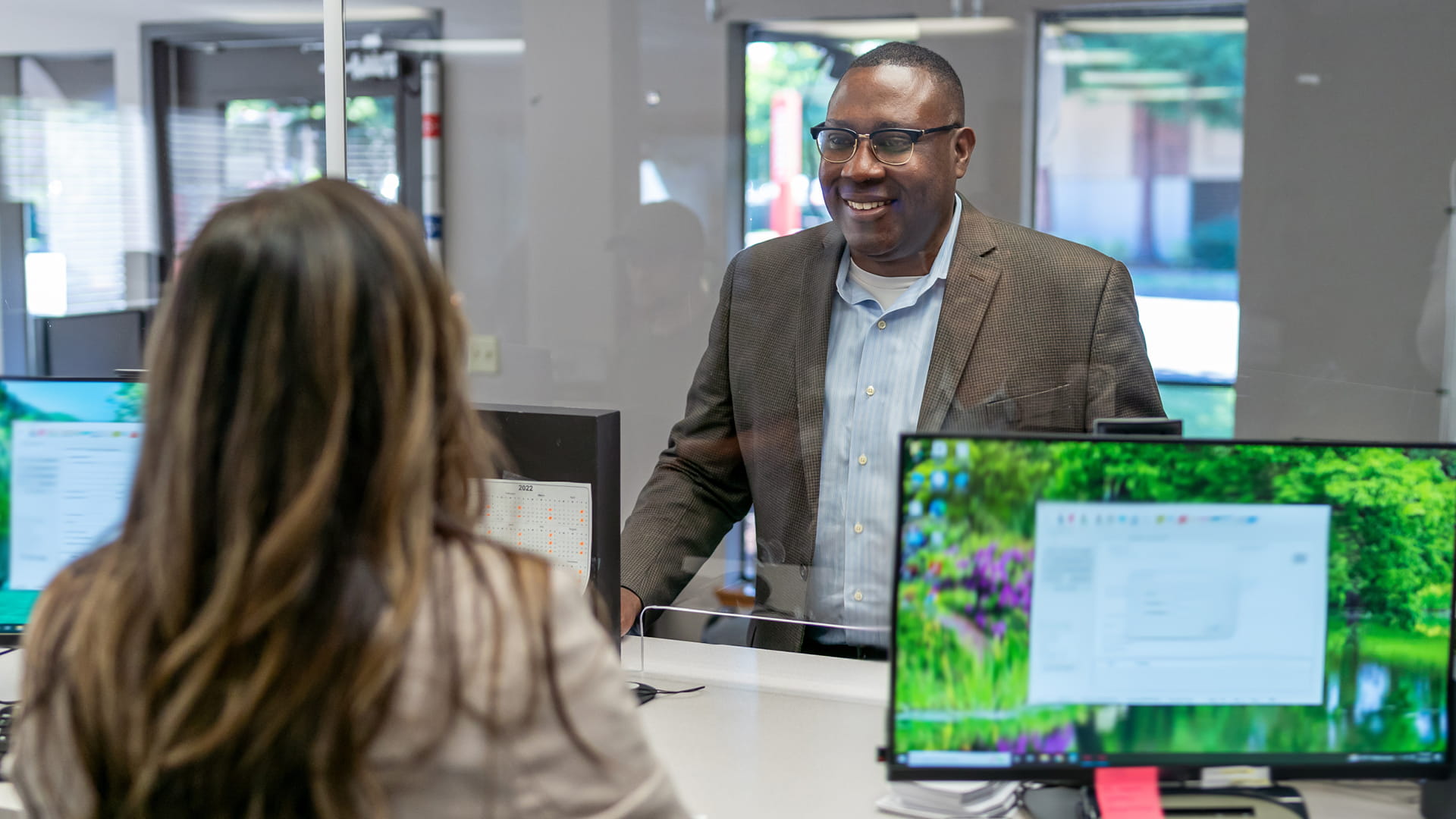 Two people speaking in office setting